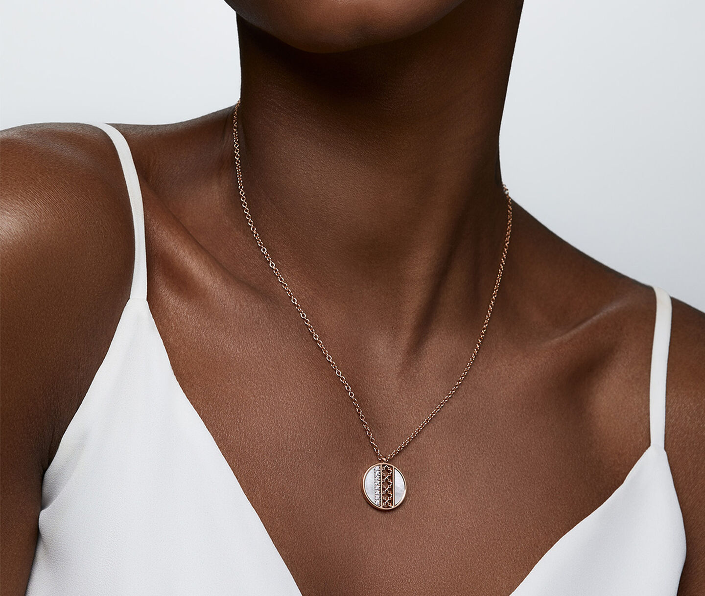 A woman wearing a Birks Dare to Dream mother-of-pearl necklace.